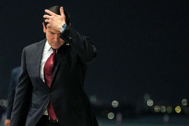 US Secretary of State Marco Rubio adjusts his hair following his arrival at al-Bateen Executive Airport in Abu Dhabi on June 23, 2026, on the first stop of a tour of Gulf states aimed at showing solidarity with key allies hit hard by the Middle East war. Rubio's delicate mission comes with Gulf countries having paid a heavy economic price for the US and Israel's decision to go to war with Iran against their wishes, prompting Tehran to lash out at its regional neighbours. (Photo by Eric Lee / POOL / AFP)