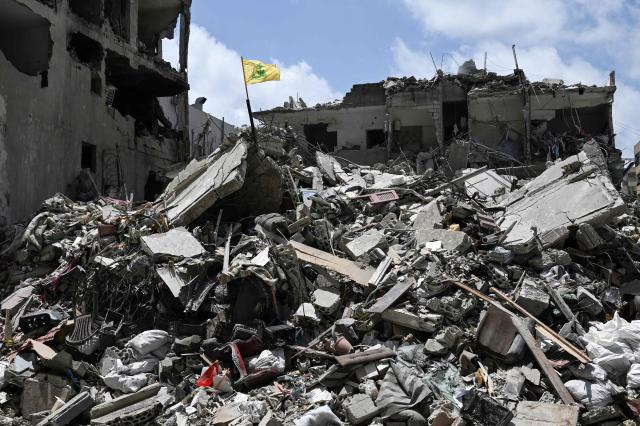 A yellow flag belonging to the Iran-backed Shia Muslim party Hezbollah flutters on top of the rubble of a building in the southern Lebanese coastal city of Tyre on June 23, 2026. Hezbollah chief on June 23, 2026, demanded a full, scheduled withdrawal of Israeli troops from Lebanon to make way for a Lebanese army deployment in the south following the US-Iran deal to end the Middle East war. (Photo by Joseph EID / AFP) / 