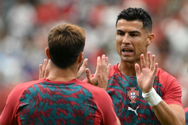 Portugal's forward #07 Cristiano Ronaldo (R) reacts during warm up prior to the  2026 World Cup Group K football match between Portugal and Uzbekistan at the Houston Stadium in Houston on June 23, 2026.  (Photo by RONALDO SCHEMIDT / AFP)