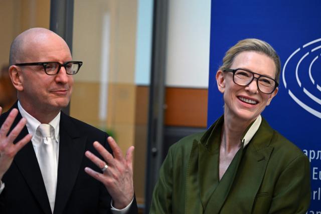 S director Steven Soderbergh (L) and Australian actress and producer Cate Blanchett (R) react as they arrive at the launch of the "RSL Media Human Consent Registry to Protect Identity in the Age of AI", at the EU Parliament in Brussels on June 23, 2026. (Photo by Nicolas TUCAT / AFP)
