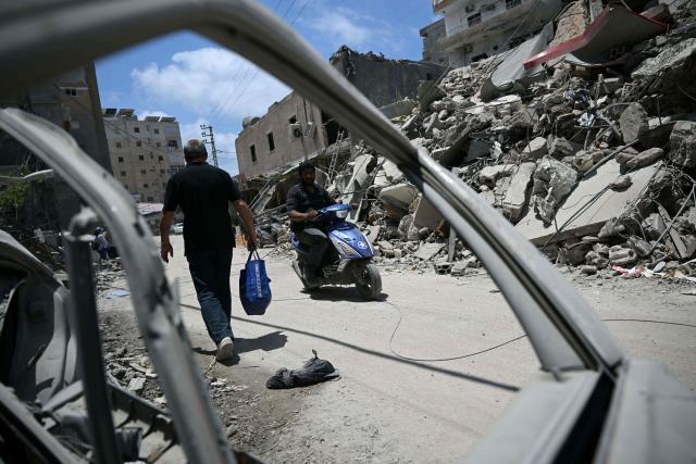A man walks past the rubble a building hit in earlier Israeli military strikes on a neighbourhood in the southern Lebanese coastal city of Tyre on June 23, 2026. On June 22, 2026, mediators Pakistan and Qatar said that Tehran and Washington had agreed to set up a "de-confliction cell" to limit flare-ups in Lebanon following talks in Switzerland on ending the wider Middle East war, which Tehran has linked to halting the parallel conflict in Lebanon. (Photo by Joseph EID / AFP) / 