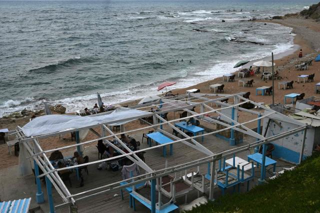 Residents cool off in the Mediterranean Sea in the southern Lebanese coastal city of Tyre on June 23, 2026, days after the city saw numerous Israeli military strikes. On June 22, 2026, mediators Pakistan and Qatar said that Tehran and Washington had agreed to set up a "de-confliction cell" to limit flare-ups in Lebanon following talks in Switzerland on ending the wider Middle East war, which Tehran has linked to halting the parallel conflict in Lebanon. (Photo by Joseph EID / AFP) / 
