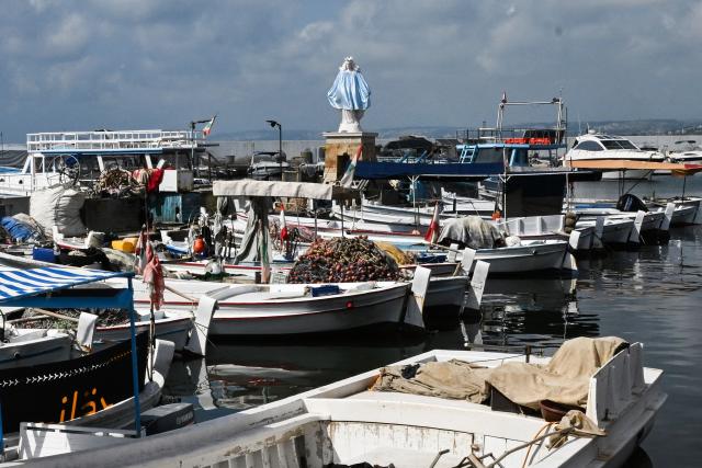 A statue of the Virgin Mary, The Lady of The Seas, overlooks the fishermen port in the southern Lebanese coastal city of Tyre on June 23, 2026, days after the city saw numerous Israeli military strikes. On June 22, 2026, mediators Pakistan and Qatar said that Tehran and Washington had agreed to set up a "de-confliction cell" to limit flare-ups in Lebanon following talks in Switzerland on ending the wider Middle East war, which Tehran has linked to halting the parallel conflict in Lebanon. (Photo by Joseph EID / AFP) / 