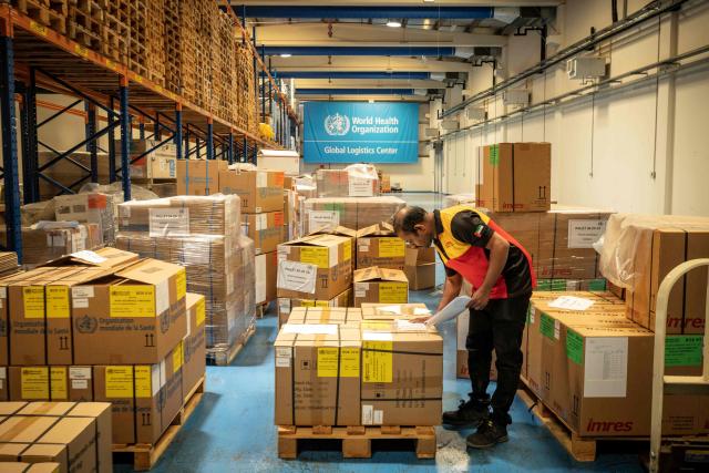 Workers pack humanitarian aid destined to countries in need at the International Humanitarian City in Dubai, on June 18, 2026. The director of a Dubai-based humanitarian logistics hub said he hoped the accord between Iran and the United States to halt the Mideast war would drive down aid delivery costs after the shocks brought on by the conflict. With more than 150,000 square metres (1.6 million square feet) of warehouse space, Dubai Humanitarian is the largest such hub in the world, and is used by dozens of organisations and UN agencies to respond to aid needs in the Middle East, Africa and Southeast Asia, taking advantage of the UAE's location and connectivity. (Photo by FADEL SENNA / AFP)