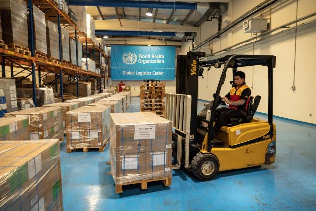 Workers pack humanitarian aid destined to countries in need at the International Humanitarian City in Dubai, on June 18, 2026. The director of a Dubai-based humanitarian logistics hub said he hoped the accord between Iran and the United States to halt the Mideast war would drive down aid delivery costs after the shocks brought on by the conflict. With more than 150,000 square metres (1.6 million square feet) of warehouse space, Dubai Humanitarian is the largest such hub in the world, and is used by dozens of organisations and UN agencies to respond to aid needs in the Middle East, Africa and Southeast Asia, taking advantage of the UAE's location and connectivity. (Photo by FADEL SENNA / AFP)