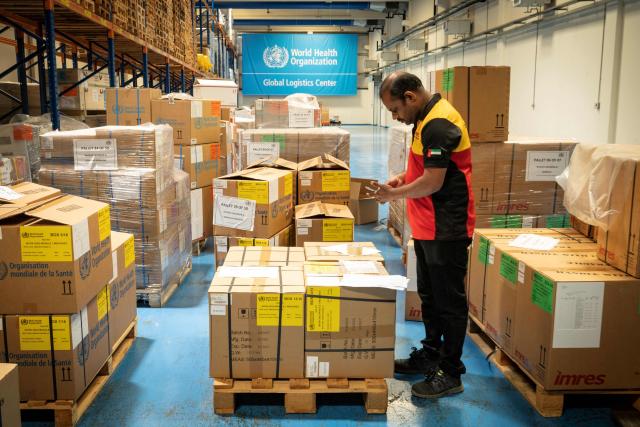 Workers pack humanitarian aid destined to countries in need at the International Humanitarian City in Dubai, on June 18, 2026. The director of a Dubai-based humanitarian logistics hub said he hoped the accord between Iran and the United States to halt the Mideast war would drive down aid delivery costs after the shocks brought on by the conflict. With more than 150,000 square metres (1.6 million square feet) of warehouse space, Dubai Humanitarian is the largest such hub in the world, and is used by dozens of organisations and UN agencies to respond to aid needs in the Middle East, Africa and Southeast Asia, taking advantage of the UAE's location and connectivity. (Photo by FADEL SENNA / AFP)