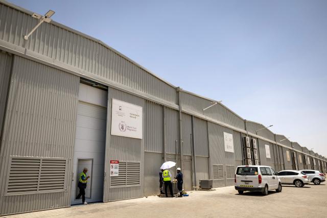 A general view of the Dubai humanitarian warehouse at the International Humanitarian City in Dubai, on June 18, 2026. The director of a Dubai-based humanitarian logistics hub said he hoped the accord between Iran and the United States to halt the Mideast war would drive down aid delivery costs after the shocks brought on by the conflict. With more than 150,000 square metres (1.6 million square feet) of warehouse space, Dubai Humanitarian is the largest such hub in the world, and is used by dozens of organisations and UN agencies to respond to aid needs in the Middle East, Africa and Southeast Asia, taking advantage of the UAE's location and connectivity. (Photo by FADEL SENNA / AFP)