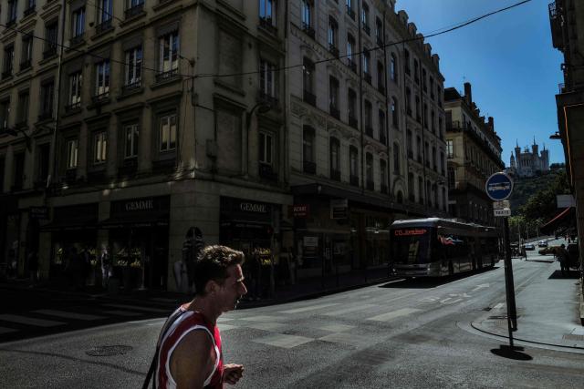 This photograph show bus and pedestrians in the Grenette street in Lyon on June 23, 2026. The Grenette street in central Lyon is testing the cohabitation between the ecologist city council and the Metropolis, which has just swung to the right. (Photo by OLIVIER CHASSIGNOLE / AFP)