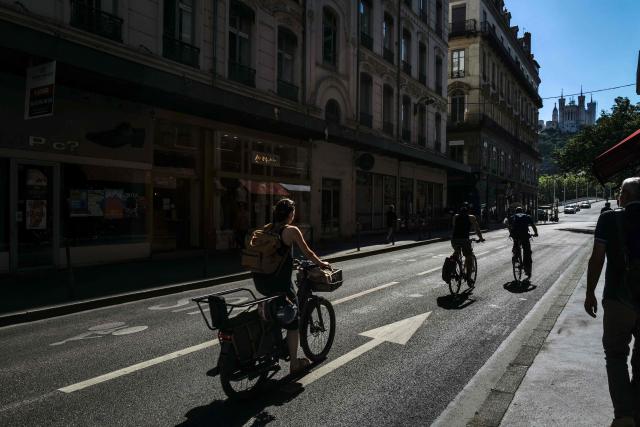 This photograph shows bikes and pedestrians in the Grenette street in Lyon on June 23, 2026. The Grenette street in central Lyon is testing the cohabitation between the ecologist city council and the Metropolis, which has just swung to the right. (Photo by OLIVIER CHASSIGNOLE / AFP)