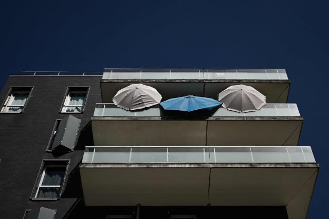Opened umbrellas are displayed on a balcony of a residential building as residents improvised shade against extreme temperatures during a heatwave in Bordeaux, south-western France on June 23, 2026. France on June 23, 2026 experienced its hottest day since measurements began in 1947, the national weather agency said. A deadly heatwave has battered France since last week, disrupting daily life and forcing the early closure of top Paris tourist hotspots. (Photo by Philippe LOPEZ / AFP)