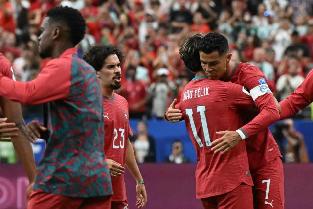 Portugal's forward #07 Cristiano Ronaldo (R) celebrates with teammates after scoring the opening goal during the 2026 World Cup Group K football match between Portugal and Uzbekistan at the Houston Stadium in Houston on June 23, 2026.  (Photo by RONALDO SCHEMIDT / AFP)