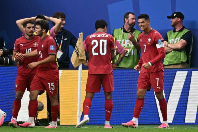 Portugal's forward #07 Cristiano Ronaldo (R) celebrates scoring his team's third goal during the 2026 World Cup Group K football match between Portugal and Uzbekistan at the Houston Stadium in Houston on June 23, 2026.  (Photo by Paul ELLIS / AFP)