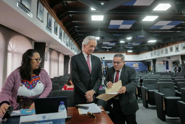 Guatemalan journalist Jose Ruben Zamora speaks with members of his legal team ahead of a hearing at the Constitutional Court (CC) in Guatemala City on June 23, 2026. Zamora, founder of the now-defunct newspaper El Periodico, has faced several judicial proceedings since 2022. Press freedom organizations have expressed concern over his case. (Photo by Edwin BERCIAN / AFP)
