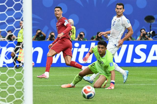 Portugal's forward #07 Cristiano Ronaldo (L) reacts as he scores his team's third goal during the 2026 World Cup Group K football match between Portugal and Uzbekistan at the Houston Stadium in Houston on June 23, 2026.  (Photo by RONALDO SCHEMIDT / AFP)