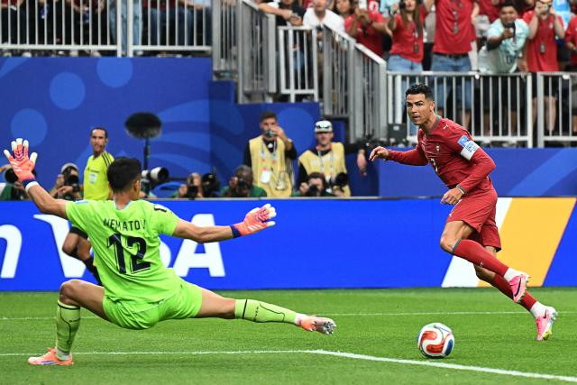 Portugal's forward #07 Cristiano Ronaldo (R) reacts as he scores his team's third goal during the 2026 World Cup Group K football match between Portugal and Uzbekistan at the Houston Stadium in Houston on June 23, 2026. Scotland and Brazil will meet in a 2026 World Cup Group C football match at the Miami Stadium in Miami Gardens on June 24, 2026. (Photo by RONALDO SCHEMIDT / AFP)