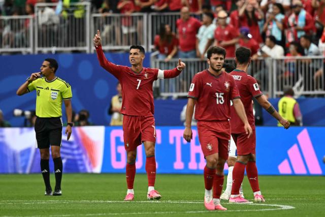 Portugal's forward #07 Cristiano Ronaldo (C) celebrates scoring his team's third goal during the 2026 World Cup Group K football match between Portugal and Uzbekistan at the Houston Stadium in Houston on June 23, 2026.  (Photo by Paul ELLIS / AFP)