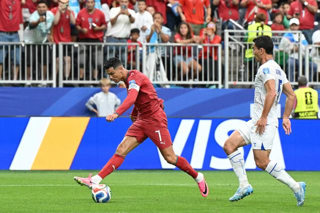 Portugal's forward #07 Cristiano Ronaldo (L) shoots and scores his team's third goal during the 2026 World Cup Group K football match between Portugal and Uzbekistan at the Houston Stadium in Houston on June 23, 2026.  (Photo by RONALDO SCHEMIDT / AFP)