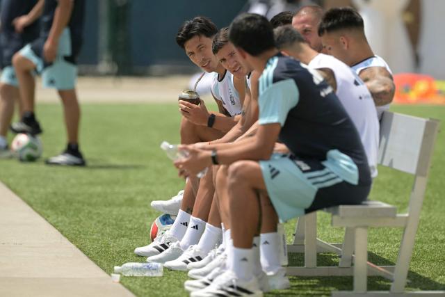 Argentina's defender #06 Lisandro Martinez (L) drinks mate during a training session at the Sporting KC Training Centre in Kansas City on June 23, 2026, during the 2026 World Cup football tournament. (Photo by Juan MABROMATA / AFP)