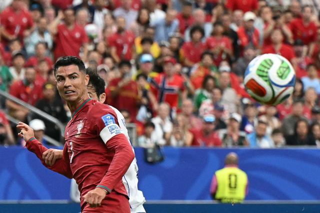 Portugal's forward #07 Cristiano Ronaldo (L) eyes the ball during the 2026 World Cup Group K football match between Portugal and Uzbekistan at the Houston Stadium in Houston on June 23, 2026.  (Photo by RONALDO SCHEMIDT / AFP)