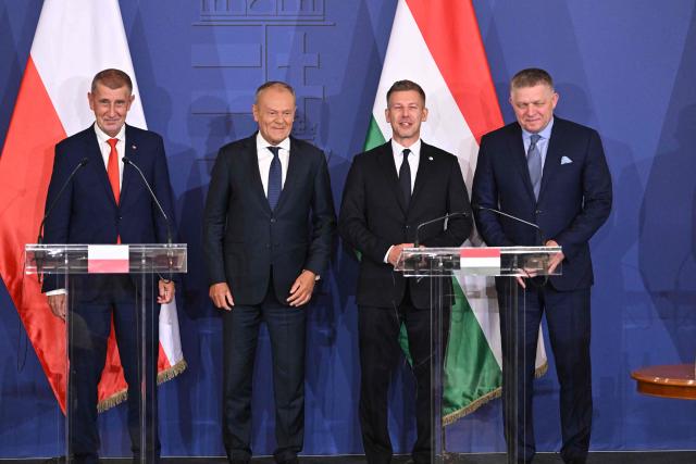 Prime Ministers of the Visegrad countries (L to R) Andrej Babis of Czech Republic, Donald Tusk of Poland,  Peter Magyar of Hungary and Robert Fico of Slovakia pose as they arrive to deliver a press conference after a meeting of the Visegrad Group (V4) in the Royal Castle of Godollo, Hungary, on June 23, 2026. The Prime Ministers of the Visegrad countries discussed about energy security, migration and EU funds during a meeting aimed to strengthen Central European cooperation and coordinate common regional interests. (Photo by Attila KISBENEDEK / AFP)