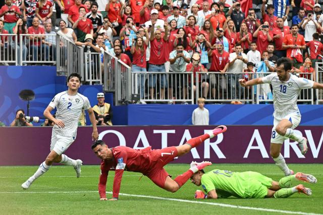 Portugal's forward #07 Cristiano Ronaldo (2nd L) falls over Uzbekistan's goalkeeper #12 Abduvohid Nematov (2nd R)  during the 2026 World Cup Group K football match between Portugal and Uzbekistan at the Houston Stadium in Houston on June 23, 2026.  (Photo by RONALDO SCHEMIDT / AFP)