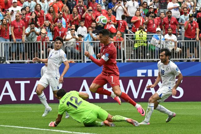 Portugal's forward #07 Cristiano Ronaldo (C) fights for the ball with  Uzbekistan's goalkeeper #12 Abduvohid Nematov (down)  during the 2026 World Cup Group K football match between Portugal and Uzbekistan at the Houston Stadium in Houston on June 23, 2026.  (Photo by RONALDO SCHEMIDT / AFP)