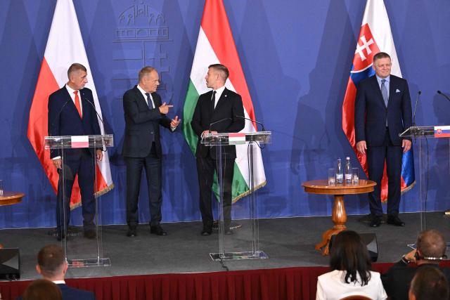 Prime Ministers of the Visegrad countries (L to R) Czech Republic's Prime Minister Andrej Babis, Poland's Prime Minister Donald Tusk, Hungarian Prime Minister Peter Magyar and Slovakia's Prime Minister Robert Fico arrive to deliver a press conference after a meeting of the Visegrad Group (V4) in the Royal Castle of Godollo, Hungary, on June 23, 2026. The Prime Ministers of the Visegrad countries discussed about energy security, migration and EU funds during a meeting aimed to strengthen Central European cooperation and coordinate common regional interests. (Photo by Attila KISBENEDEK / AFP)