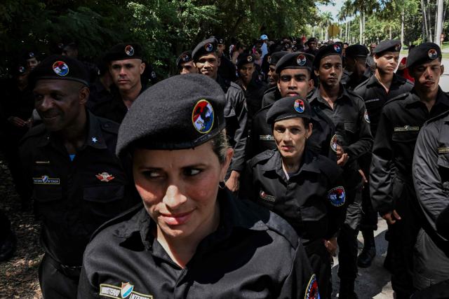 Cuba's soldiers line up in front of the Ministry of the Revolutionary Armed Forces to pay tribute to Commander Ramiro Valdés during his funeral in Havana on June 23, 2026. Ramiro Valdes Menendez, a close associate of brothers Fidel and Raul Castro and founder of the Cuban intelligence services, has died at the age of 94, Cuban President Miguel Diaz-Canel announced on June 21, 2026. (Photo by YAMIL LAGE / AFP)