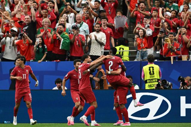 Portugal's players celebrate their fourth goal  during the 2026 World Cup Group K football match between Portugal and Uzbekistan at the Houston Stadium in Houston on June 23, 2026.  (Photo by RONALDO SCHEMIDT / AFP)