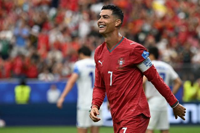 Portugal's forward #07 Cristiano Ronaldo reacts to his team's fourth goal during the 2026 World Cup Group K football match between Portugal and Uzbekistan at the Houston Stadium in Houston on June 23, 2026.  (Photo by Paul ELLIS / AFP)