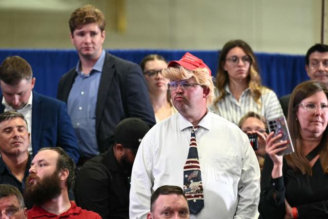 People wait for US President Donald Trump to speak at the Mack Trucks manufacturing facility in Macungie, Pennsylvania, on June 23, 2026. (Photo by Mandel NGAN / AFP)