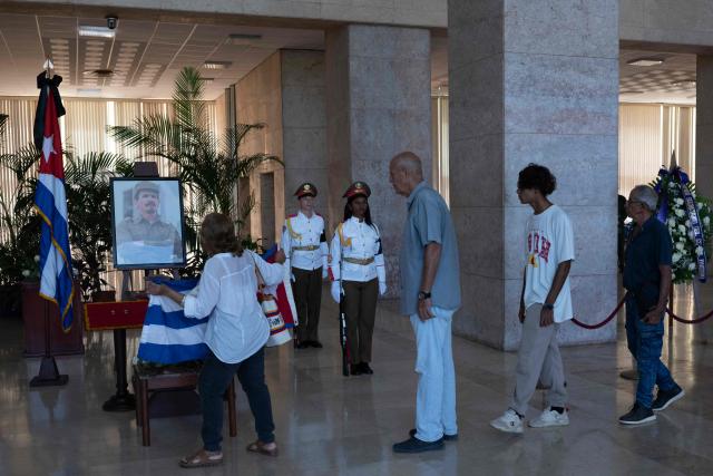 People pay tribute to the urn containing the remains of Commander Ramiro Valdes at the Ministry of the Revolutionary Armed Forces in Havana, on June 23, 2026. Ramiro Valdes Menendez, a close associate of brothers Fidel and Raul Castro and founder of the Cuban intelligence services, has died at the age of 94, Cuban President Miguel Diaz-Canel announced on June 21, 2026. (Photo by Pablo PORCIUNCULA / AFP)