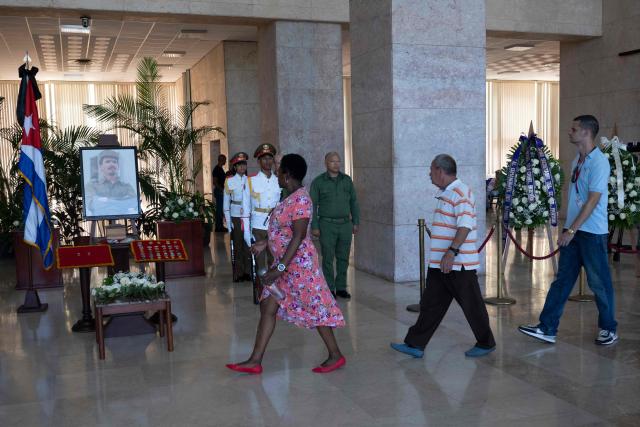 People pay tribute to the urn containing the remains of Commander Ramiro Valdes at the Ministry of the Revolutionary Armed Forces in Havana, on June 23, 2026. Ramiro Valdes Menendez, a close associate of brothers Fidel and Raul Castro and founder of the Cuban intelligence services, has died at the age of 94, Cuban President Miguel Diaz-Canel announced on June 21, 2026. (Photo by Pablo PORCIUNCULA / AFP)