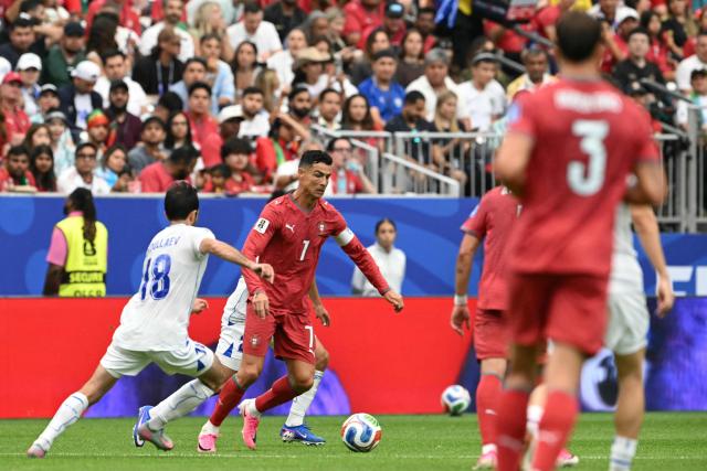 Portugal's forward #07 Cristiano Ronaldo (C) runs with the ball during the 2026 World Cup Group K football match between Portugal and Uzbekistan at the Houston Stadium in Houston on June 23, 2026.  (Photo by RONALDO SCHEMIDT / AFP)
