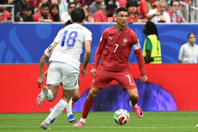 Portugal's forward #07 Cristiano Ronaldo (R) runs with the ball during the 2026 World Cup Group K football match between Portugal and Uzbekistan at the Houston Stadium in Houston on June 23, 2026.  (Photo by RONALDO SCHEMIDT / AFP)