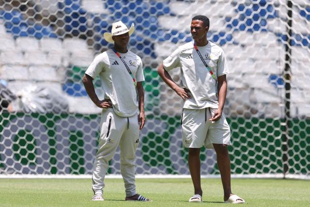 South Africa's defender #14 Mbekezeli Mbokazi (L) and defender #03 Khulumani Ndamane walk on the pitch at the Monterrey Stadium in Mexico on June 23, 2026, on the eve of the 2026 World Cup match between South Africa and South Korea. (Photo by Julio Cesar AGUILAR / AFP)