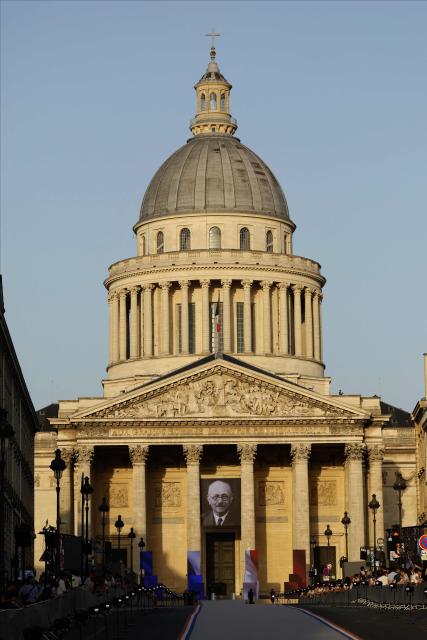 A portrait of the late historian and resistance fighter Marc Bloch adorns the facade of the Pantheon before his induction ceremony along with his wife Simonne Vidal, in Paris on June 23, 2026. Historian Marc Bloch, a soldier and Resistance fighter murdered by the Gestapo, will be inducted into Frances Panthéon on June 23 in a tribute to the author of "Strange Defeat", a major work tahat President Emmanuel Macron has described as a warning against the "conformism" that undermines the "French will."
The ceremony marks the sixth Panthéon induction of Macron's two terms, following those of Simone Veil, writer Maurice Genevoix, Josephine Baker, Resistance fighter Missak Manouchian and Robert Badinter. (Photo by Yoan VALAT / POOL / AFP)