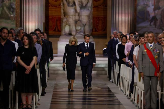 France's President Emmanuel Macron and his wife Brigitte Macron attend the Pantheon induction ceremony for the late historian and resistance fighter Marc Bloch and his wife Simonne Bloch in Paris on June 23, 2026. Historian Marc Bloch, a soldier and Resistance fighter murdered by the Gestapo, will be inducted into Frances Panthéon on June 23 in a tribute to the author of "Strange Defeat", a major work tahat President Emmanuel Macron has described as a warning against the "conformism" that undermines the "French will."
The ceremony marks the sixth Panthéon induction of Macron's two terms, following those of Simone Veil, writer Maurice Genevoix, Josephine Baker, Resistance fighter Missak Manouchian and Robert Badinter. (Photo by Alice Sacco / POOL / AFP)