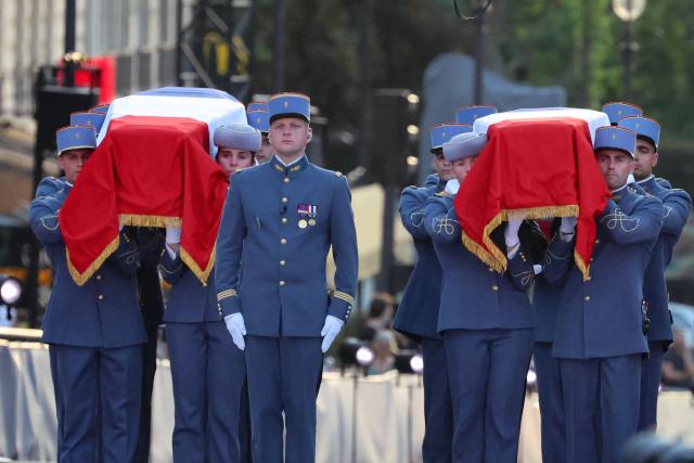 Empty coffins, symbolically representing the late historian and resistance fighter Marc Bloch and his wife Simonne Bloch are carried during his Pantheon induction ceremony in Paris on June 23, 2026. Historian Marc Bloch, a soldier and Resistance fighter murdered by the Gestapo, will be inducted into Frances Panthéon on June 23 in a tribute to the author of "Strange Defeat", a major work tahat President Emmanuel Macron has described as a warning against the "conformism" that undermines the "French will."
The ceremony marks the sixth Panthéon induction of Macron's two terms, following those of Simone Veil, writer Maurice Genevoix, Josephine Baker, Resistance fighter Missak Manouchian and Robert Badinter. (Photo by Ludovic MARIN / AFP)