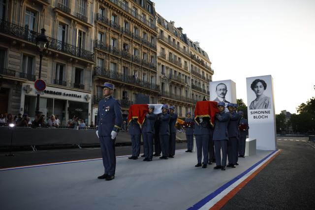 Soldiers carry the cenotaphs of the late historian and resistance fighter Marc Bloch and his wife Simonne Bloch during his Pantheon induction ceremony in Paris on June 23, 2026. Historian Marc Bloch, a soldier and Resistance fighter murdered by the Gestapo, will be inducted into Frances Panthéon on June 23 in a tribute to the author of "Strange Defeat", a major work tahat President Emmanuel Macron has described as a warning against the "conformism" that undermines the "French will."
The ceremony marks the sixth Panthéon induction of Macron's two terms, following those of Simone Veil, writer Maurice Genevoix, Josephine Baker, Resistance fighter Missak Manouchian and Robert Badinter. (Photo by Yoan VALAT / POOL / AFP)