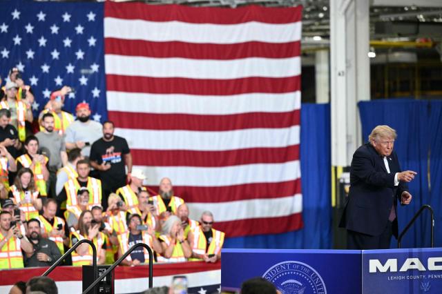 US President Donald Trump points to the crowd during a visit to the Mack Trucks manufacturing facility in Macungie, Pennsylvania, on June 23, 2026. (Photo by Mandel NGAN / AFP)