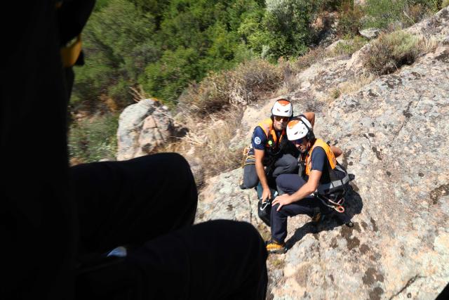 Members of Ajaccio's High Mountain Gendarmerie Platoon (PGHM, Peleton de Gendarmerie de Haute Montagne), an elite unit of the French Gendarmerie specialising in mountain rescue and law enforcement in high-altitude and alpine environments, are dropped from the helicopter to evacuate an injured man close from Ajaccio on the French Mediterranean island of Corsica on June 23, 2026. (Photo by Pascal POCHARD-CASABIANCA / AFP)