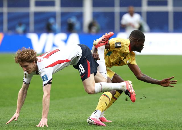 England's forward #18 Anthony Gordon (L) falls as he  fights for the ball with Ghana's midfielder #05 Thomas Partey  during the 2026 World Cup Group L football match between England and Ghana at the Boston Stadium in Foxborough on June 23, 2026.  (Photo by FRANCK FIFE / AFP)