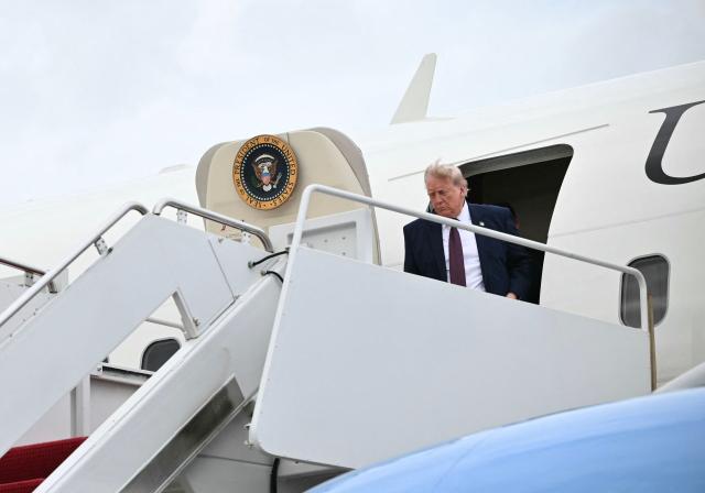 US President Donald Trump steps off Air Force One at Joint Base Andrews, Maryland, on June 23, 2026. (Photo by Mandel NGAN / AFP)