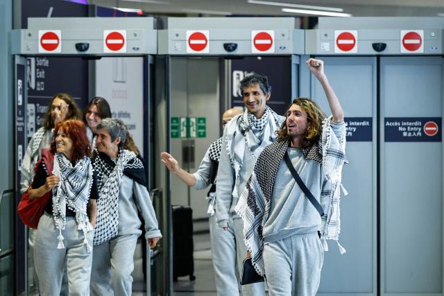 (FILES) French activists detained and deported by Israel following the interception of their Gaza-bound flotilla arrive at Roissy Charles de Gaulle airport near Paris on May 22, 2026. International condemnation has mounted since May 2026 regarding the treatment of these 430 activists, including around 30 French nationals. France and Italy have launched judicial investigations into allegations of torture and war crimes, which will seek to establish who is responsible, whilst Australia has announced an independent inquiry. The Israeli authorities have rejected these accusations. (Photo by SIMON WOHLFAHRT / AFP)