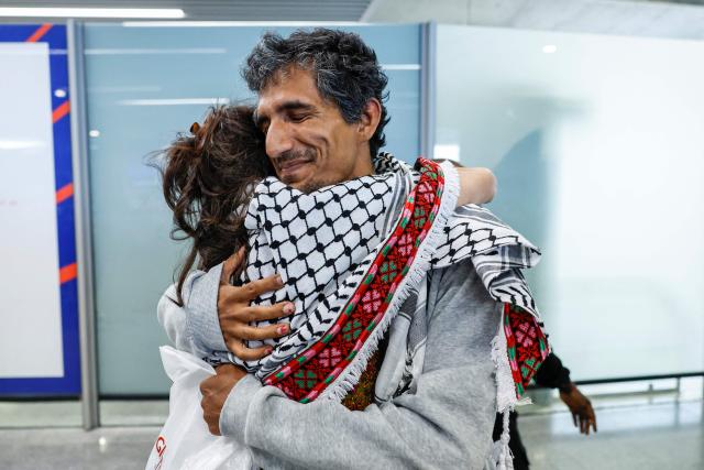 (FILES) A French activist detained and deported by Israel following the interception of their Gaza-bound flotilla hugs a relative as they arrive at Roissy Charles de Gaulle airport near Paris on May 22, 2026. International condemnation has mounted since May 2026 regarding the treatment of these 430 activists, including around 30 French nationals. France and Italy have launched judicial investigations into allegations of torture and war crimes, which will seek to establish who is responsible, whilst Australia has announced an independent inquiry. The Israeli authorities have rejected these accusations. (Photo by SIMON WOHLFAHRT / AFP)