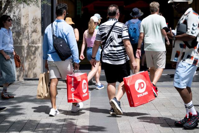 (FILES) People carry shopping bags on the first day of the French summer sales in Paris on June 25, 2025. The summer sales kick off on June 24, 2026, amid scorching heat, "a godsend" for air-conditioned department stores where consumers take refuge, but a source of concern for downtown shops, which fear purchases will shift to ultra-fast-fashion online platforms. (Photo by Emma DA SILVA / AFP)
