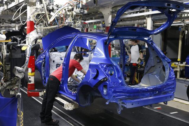 (FILES) Employees work on the assembly line to build Yaris cars at Toyota's automobile manufacturing plant in Onnaing, northern France, January 22, 2018. Workers in the automotive sector are suffocating in the face of the very high temperatures that are driving up the mercury in factories, where production is not slowing down. The Nord department, which will go on red heatwave alert on June 24 at noon, is expected to experience an incandescent end of the week, with temperatures of up to 39 degrees locally according to Météo-France. (Photo by PASCAL ROSSIGNOL / AFP)