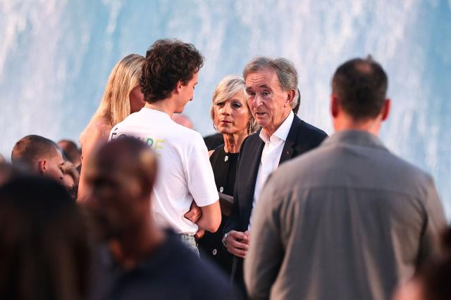 LVMH chairman and CEO Bernard Arnault (C) looks on as he arrives for the Louis Vuitton Menswear Spring/Summer 2027 collection fashion show as part of the Paris Fashion Week, in Paris, on June 23, 2026. (Photo by SIMON WOHLFAHRT / AFP)
