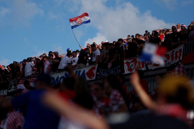A Croatian waves a national flag ahead of the 2026 World Cup Group L football match between Panama and Croatia at the Toronto Stadium in Toronto on June 23, 2026.  (Photo by Cole Burston / AFP)